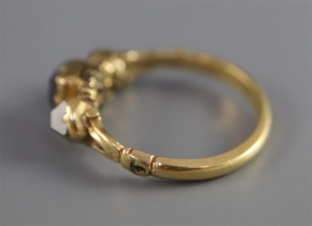A Georgian 18ct gold, three stone diamond and black enamel ring,